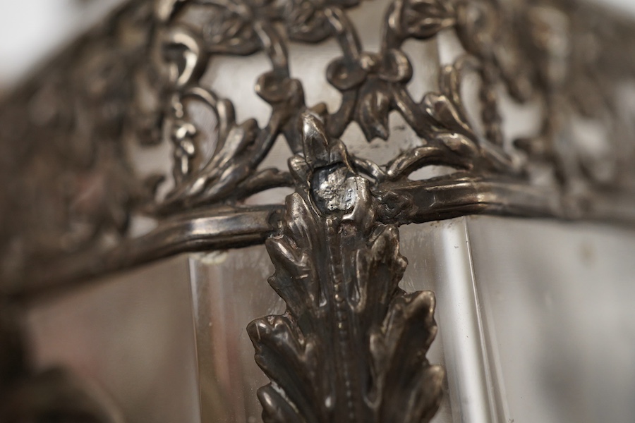 A late 19th/early 20th century French 800 standard pierced white metal mounted glass jar or tea caddy and stopper, decorated with classical scene of a lady with child, height 13.2cm.
